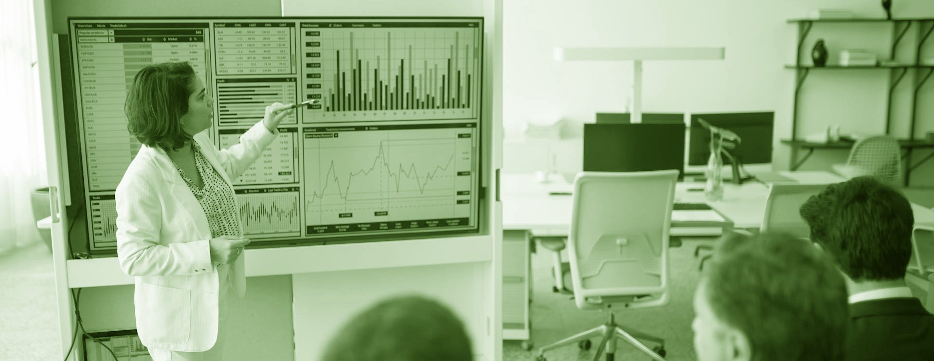 Woman giving a data presentation to executives green banner