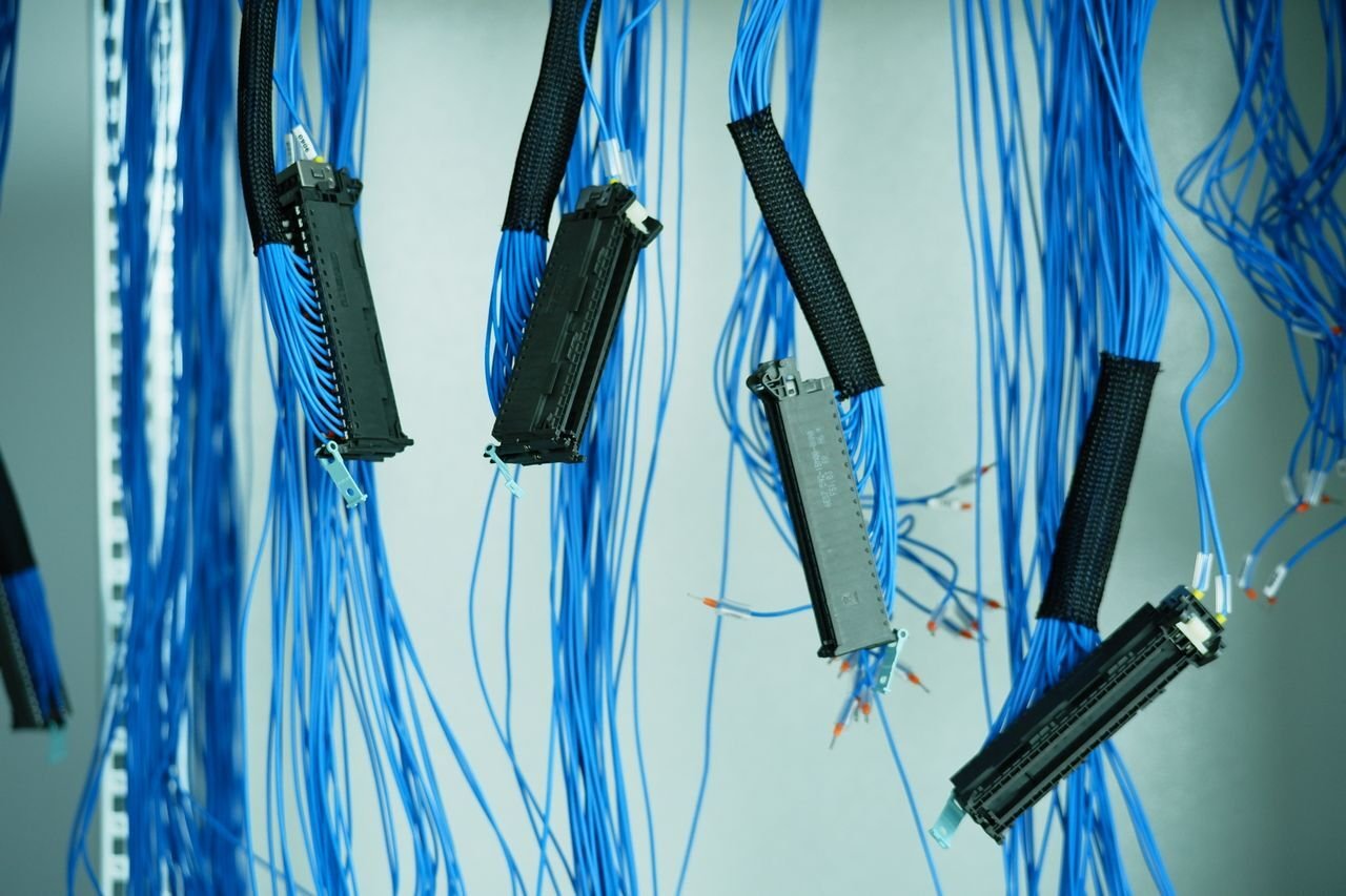 data cables hanging into thin air to represent idea of disconnected systems and technical debt AI debt